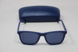 A pair of as new Lacoste sunglasses.