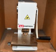 A pre-owned Instron hollow die punch (C-6051-000).