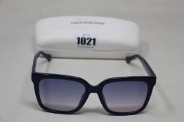 A pair of as new Calvin Klein sunglasses.