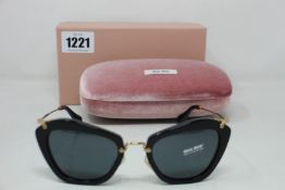 A pair of as new Miu Miu sunglasses.