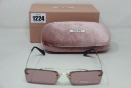 A pair of as new Miu Miu sunglasses.