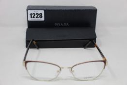 A pair of as new Prada glasses frames.