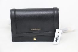 An as new Michael Kors Jet Set bag in black.