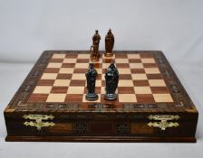 A Gifthome historical chess set with metal pieces and decorative wooden board.