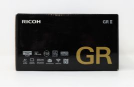 A boxed as new Ricoh GR II 16MP Compact Camera in Black (Box opened, two pin plug included).