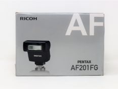 A boxed as new Pentax AF201FG Compact Auto Flash (Box opened, damaged box).
