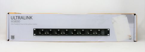 A boxed as new Behringer ULTRALINK MS8000 8 Channel Microphone Splitter (Box sealed, some damage