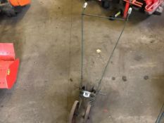 Handheld twin row hoe with wheels.