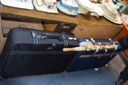 Two Canvas Suitcases and an Umbrella