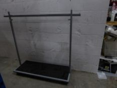 * metal rail with bottom shelf on castors. Adjustable height. 1600w x 500d x 1400h (min)