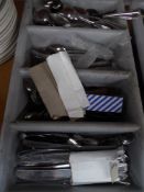* grey tray with selection of cutlery