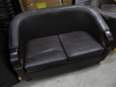 * Brown leather sofa with dark wooden detailing to arms. 1450w x 850d x 850h