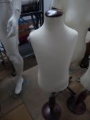 * fabric childs upper body on wooden stand