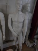 * white male mannequin with glass stand