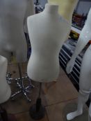 * fabric childs upper body on wooden stand