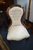 Victorian Carved Mahogany Nursing Chair with Cream Upholstery
