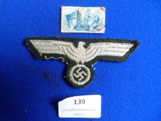 Wehrmacht Cloth Breast Eagle, and an Italian Stamp Depicting Hitler and Mussolini