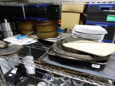 *contents of shelf large baking trays white large plates circular baking trays chopping boards label