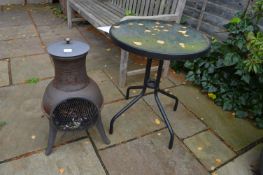 Small Outdoor Chiminea and a Patio Table with Glass Top