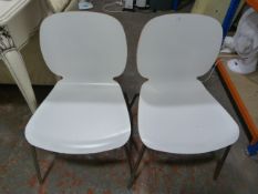 Two White Stacking Chairs