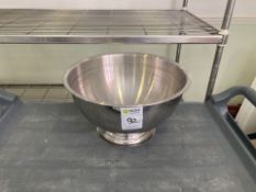 a collection of kitchen pots and sieves