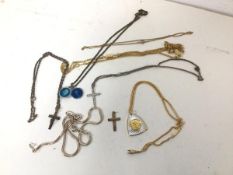 A 9ct gold crucifix (2.1g) and another with Jesus on the Cross, marked silver and other costume