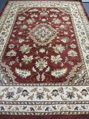 MODERN WOOLLEN LOUNGE CARPET, red and cream ground with repeating central pattern and multi-bordered