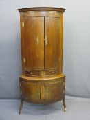 MAHOGANY TWO-PIECE BOW FRONT STANDING CORNER CABINET having twin doors and drawers to the upper
