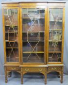 EDWARDIAN SHERATON STYLE INLAID BREAKFRONT BOOKCASE/CABINET having three lower drawers on square