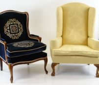 TWO WINGBACK ARMCHAIRS, comprising a George II style armchair upholstered in yellow floral damask
