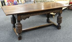 ELIZABETHAN-STYLE OAK REFECTORY TABLE, boarded top above channel carved frieze with scrolled