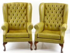 PAIR GEORGIAN-STYLE WINGBACK ARMCHAIRS, button upholstered in mustard leather (faded) (2) COLLECTING