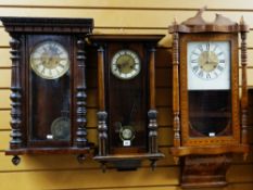 THREE 20TH CENTURY WALNUT WALL CLOCKS including an American parquetry clock with floral base,