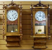 TWO AMERICAN WALNUT MARQUETRY DROP DIAL WALL CLOCKS, with 8 inch roman white enamel dials, turned