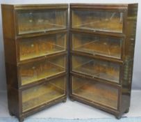OAK GLOBE-WERNICKE BOOKCASES, a pair, graduated four section with lift-up glazed doors, 146cms H,