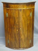 BOW FRONT MAHOGANY WALL HANGING CORNER CUPBOARD, twin door, string inlay 'H' bracket hinges with