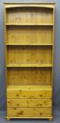 PINE BOOKSHELVES, four shelves over three base drawers on bun feet, 197cms H, 82cms W, 31cms D