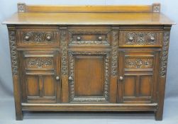 QUALITY CARVED OAK RAILBACK SIDEBOARD having three frieze drawers and lower cupboard doors on