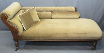 ANTIQUE CHAISE LONGUE upholstered in brown with stud detail, scroll and floral carvings on turned