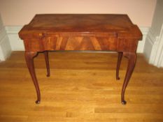 ROSEWOOD GAMES TABLE - with finely grained foldover top having a folding base on cabriole
