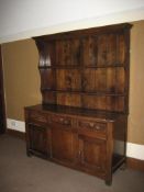 AN 18TH CENTURY OAK WELSH DRESSER, well coloured, having a twin-shelf rack with shaped ends and