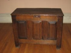 AN 18TH CENTURY SMALL OAK COFFER, the triple plank top over three fielded front panels, 105cms W