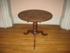 19TH CENTURY CIRCULAR OAK TRIPOD TABLE having centre turned pedestal on pad supports, 85cms