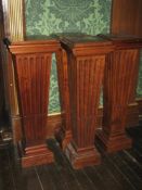 A SET OF SIX POLISHED OAK EFFECT BUST PEDESTALS having square tops and slightly tapered square bases