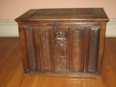 LATE 18TH CENTURY OAK COFFER having an inset lid to the top and with four narrow carved panels and a