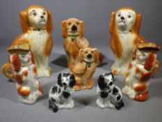 STAFFORDSHIRE POTTERY DOGS GROUP, three pairs and two others including a pair of red and white