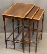 EDWARDIAN CROSSBANDED MAHOGANY NEST OF THREE SPIDER LEG OCCASIONAL TABLES, 65cms H, 56cms W, 37cms D