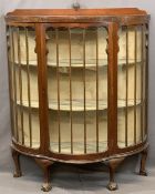 EDWARDIAN MAHOGANY SERPENTINE FRONT CHINA DISPLAY CABINET with single central door, fabric covered
