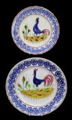 PAIR OF LLANELLY COCKEREL PLATES typically decorated with sponged floral motifs to the border,