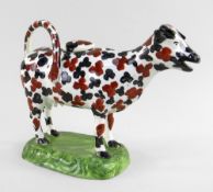 A SWANSEA CAMBRIAN PEARLWARE COW CREAMER typically modelled with tail loop-handle and standing on